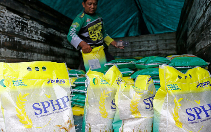 Sejumlah warga membeli beras Bulog, di Pasar Pacar Keling Surabaya, Sabtu (13/9).