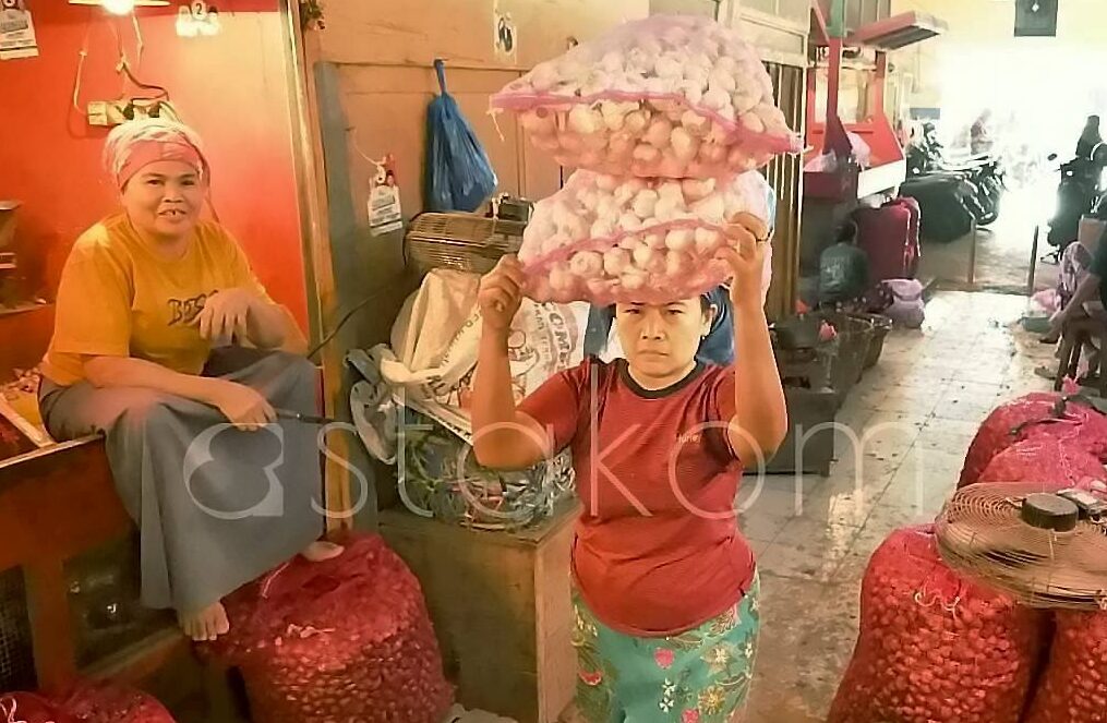 Pedagang menunjukkan stok bawang dan cabai rawit di Pasar Pabean Surabaya